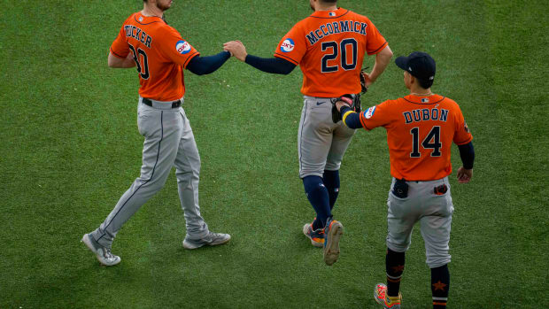 Oct 19, 2023; Arlington, Texas, USA; Houston Astros center fielder Mauricio Dubon (14) and left fielder Chas McCormick (20) and right fielder Kyle Tucker (30) celebrate the Astros victory over the Texas Rangers in game four of the ALCS for the 2023 MLB playoffs at Globe Life Field. Mandatory Credit: Jerome Miron-USA TODAY Sports